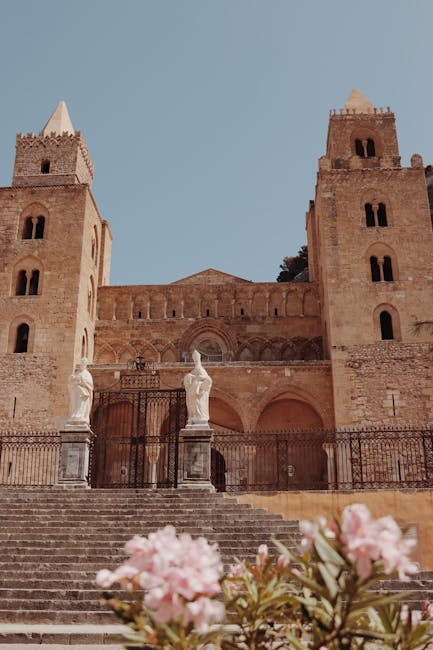 Cefalù cathedral facade with twin towers and foreground steps