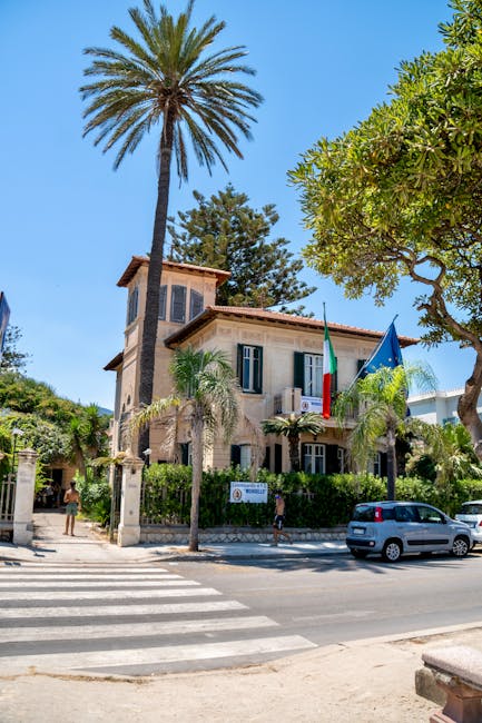 Mediterranean villa with palm trees and Italian flag on Mondello road