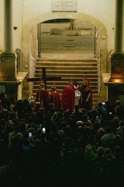Crowded Sicilian procession with robed Roman soldiers carrying a large cross