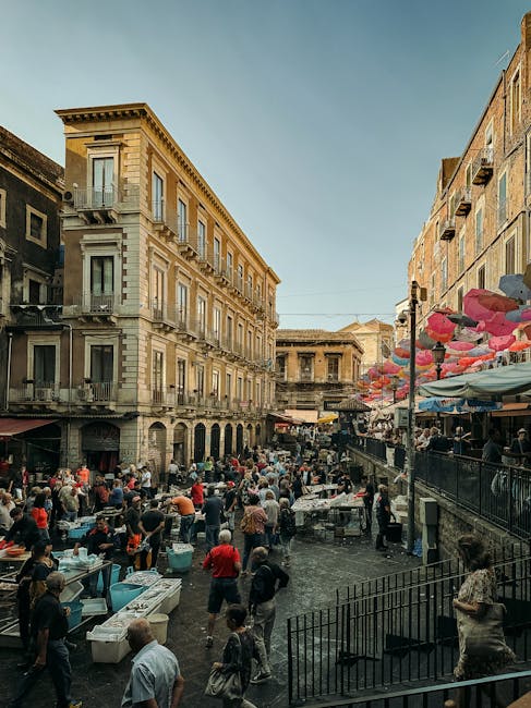 Crowded early morning market with street vendors in Catania