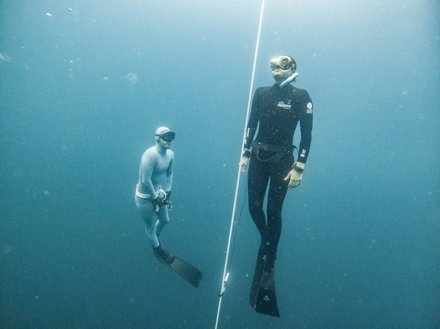 Two freedivers training beside a descent line in Sicilian waters