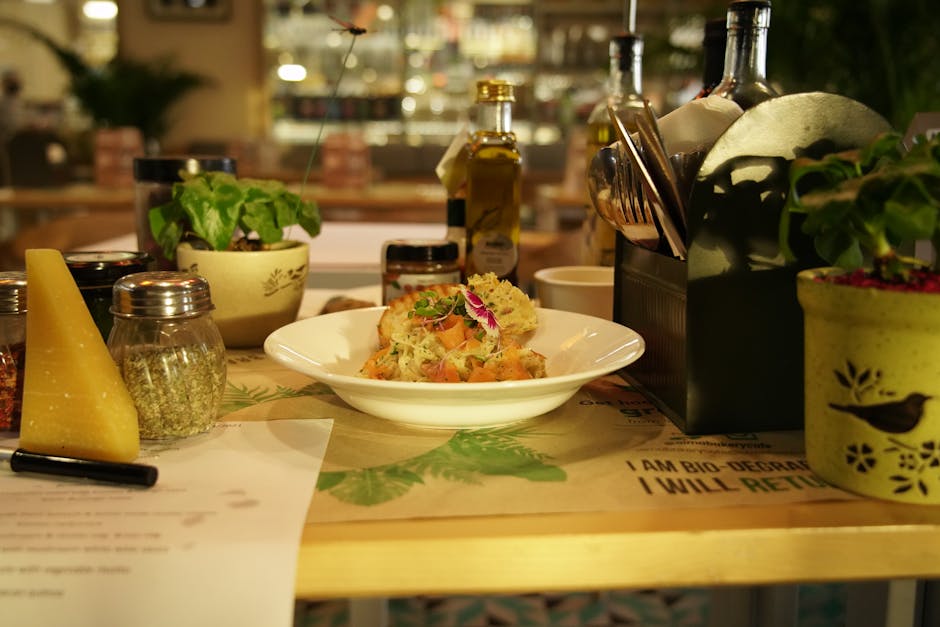 Table with plated pasta, olive oil, and cheese in Sicilian trattoria