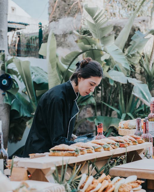 Chef arranging sandwiches at an outdoor Sicilian street-food stall
