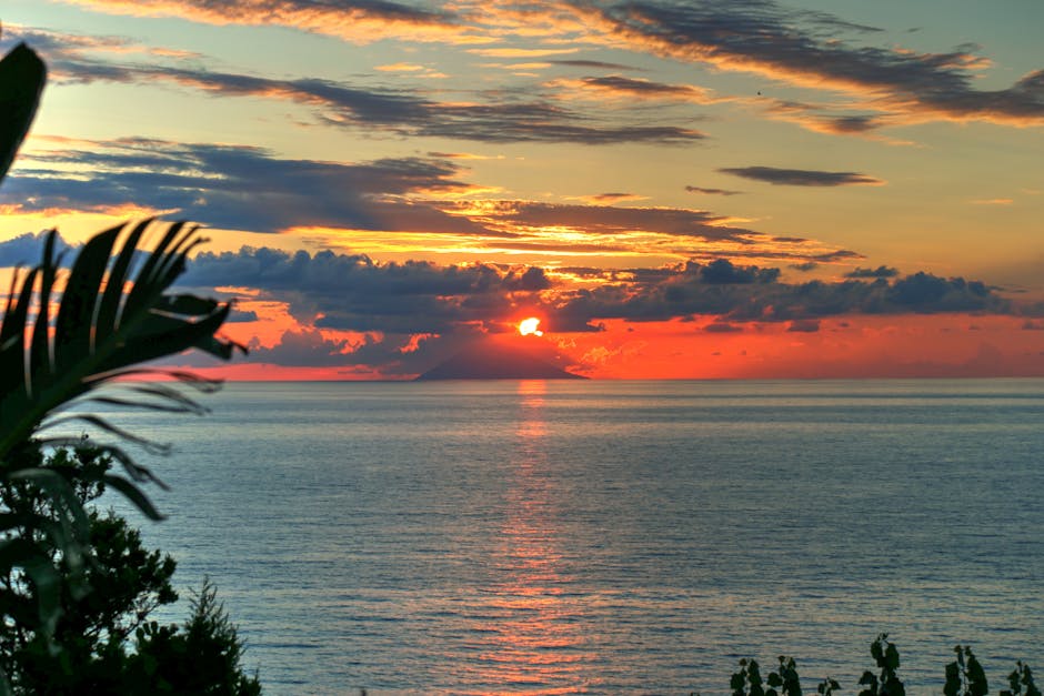 Sunset over the sea with distant island silhouette off Sicily