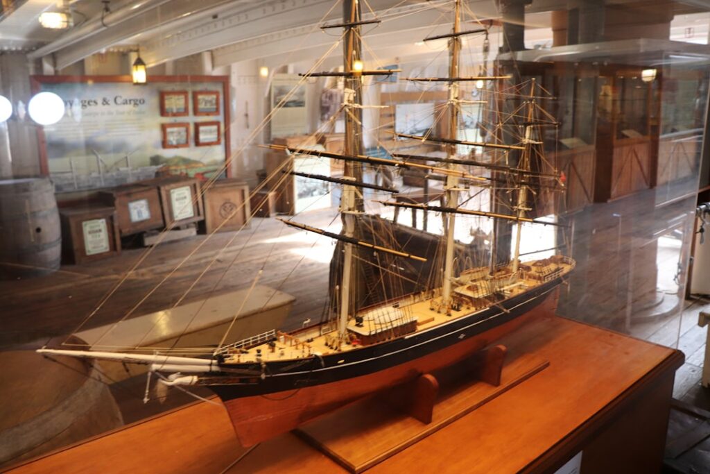 Detailed wooden ship model displayed inside a maritime exhibit near Lake Maggiore