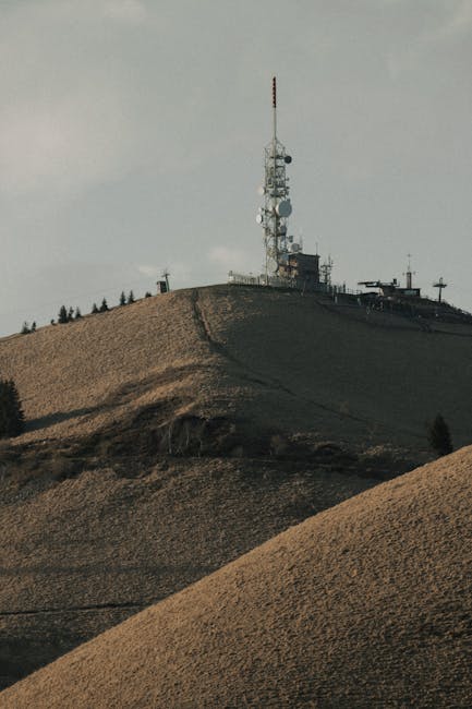 Radio tower perched on a grassy hilltop above the Lac Majeur region