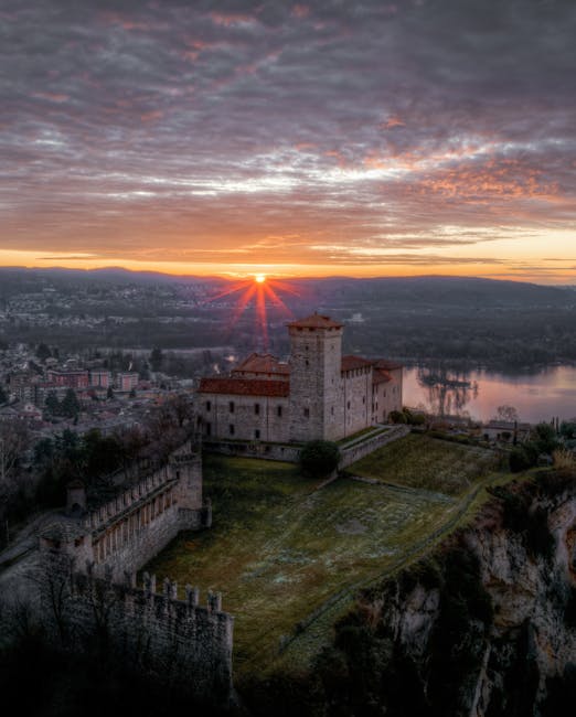 Hilltop castle above Lac Majeur at sunrise with dramatic sunburst