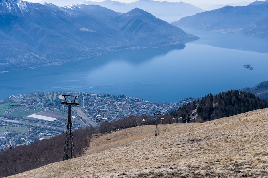 Vue en contrebas sur une ville et le Lac Majeur encadré par montagnes