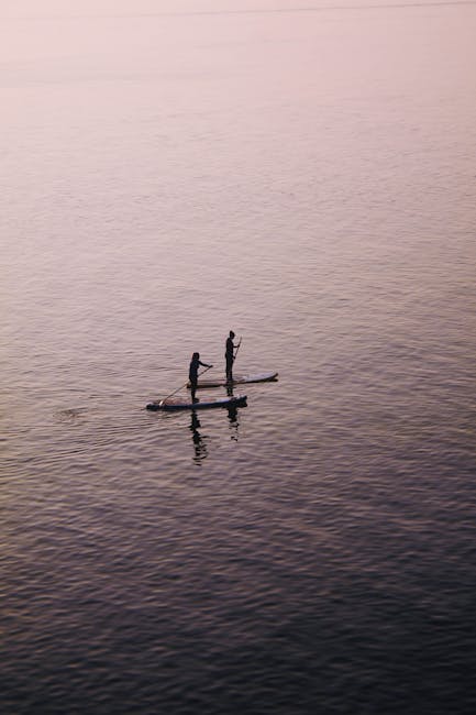 Due persone in paddleboard sul Lago Maggiore al tramonto