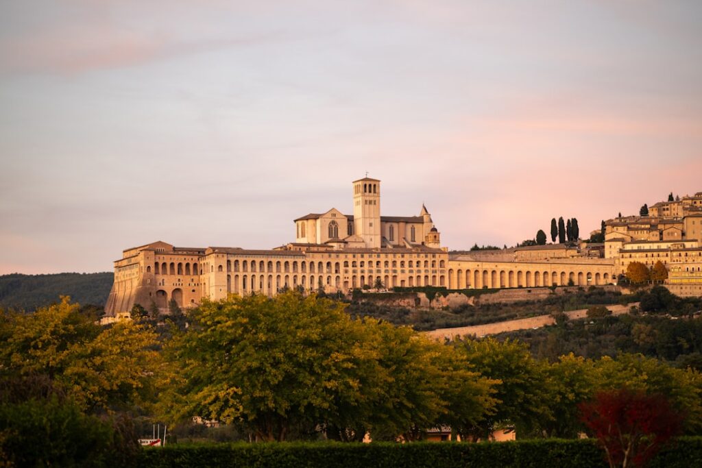 Basilica of Saint Francis rising above Assisi, Umbria, at golden sunset