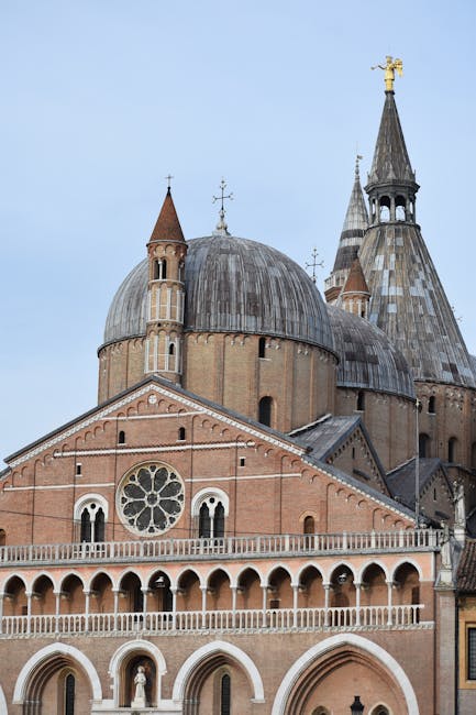 Historic brick basilica façade and domes in Assisi, Umbria