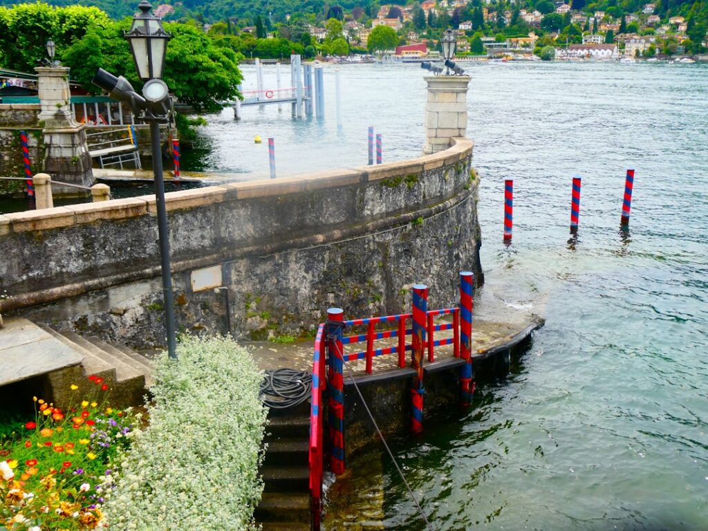 Quai en pierre orné de poteaux rouges et bleus au lac Trasimène