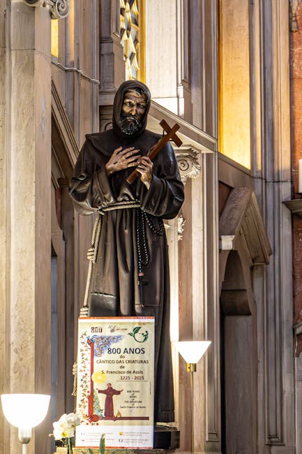 Wooden statue of a Franciscan friar holding a cross in Assisi