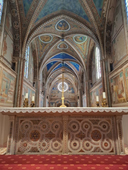 Gilded processional cross in front of rose window inside Umbria basilica
