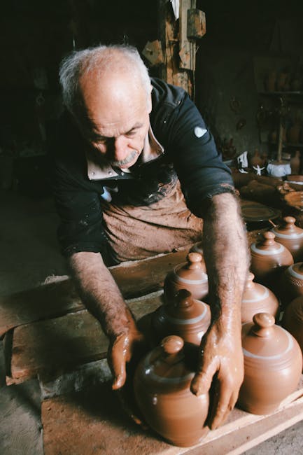 Artisan potter in Umbria shaping clay jars with skilled hands