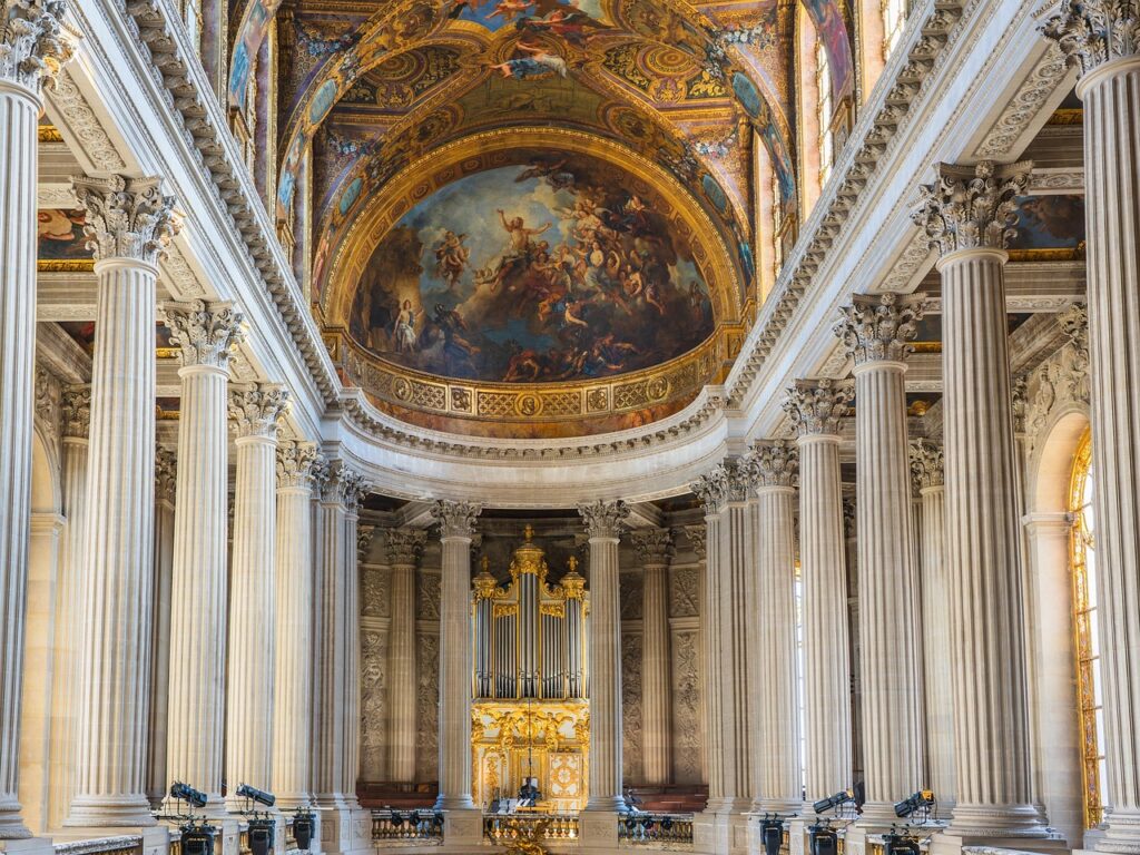 Interno riccamente affrescato con colonne e organo nella chiesa umbra