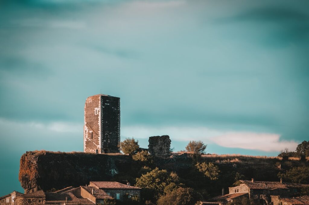 Solitary medieval tower ruin perched on rocky ridge above Umbria village