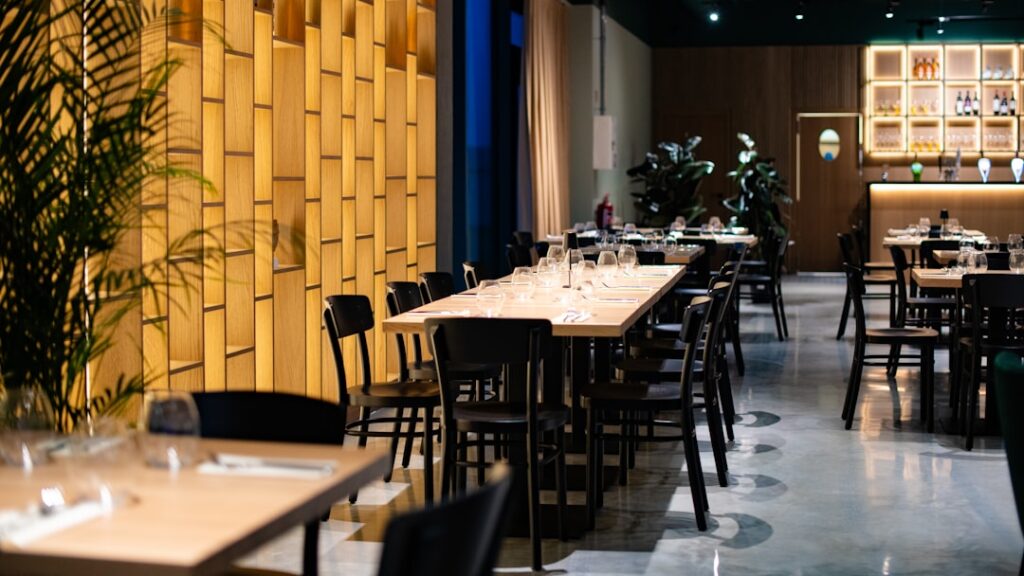 Modern Calabria restaurant interior with wooden tables set for dining