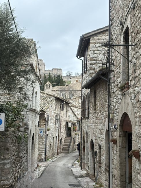 Narrow stone alley flanked by ancient limestone houses in Calabria