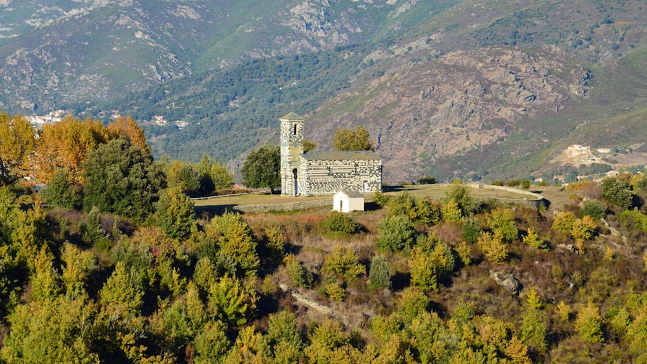 Small hilltop stone church overlooking wooded hills in Calabria