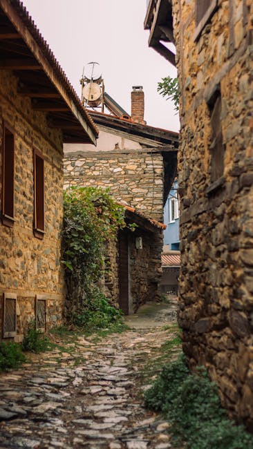 Cobblestone alley between rustic stone houses in a Calabria village