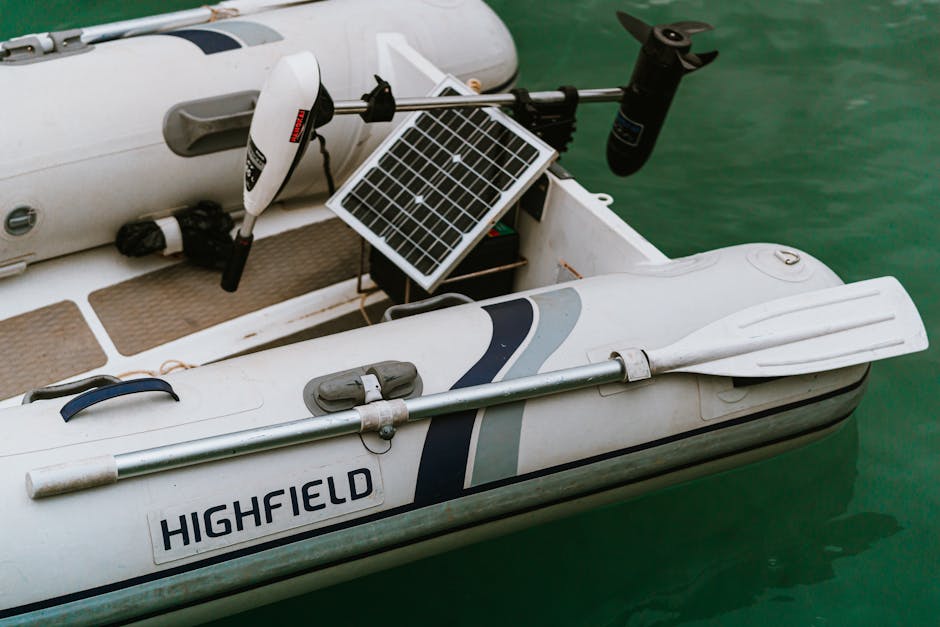 Inflatable dinghy with oar and solar panel on Lake Arvo