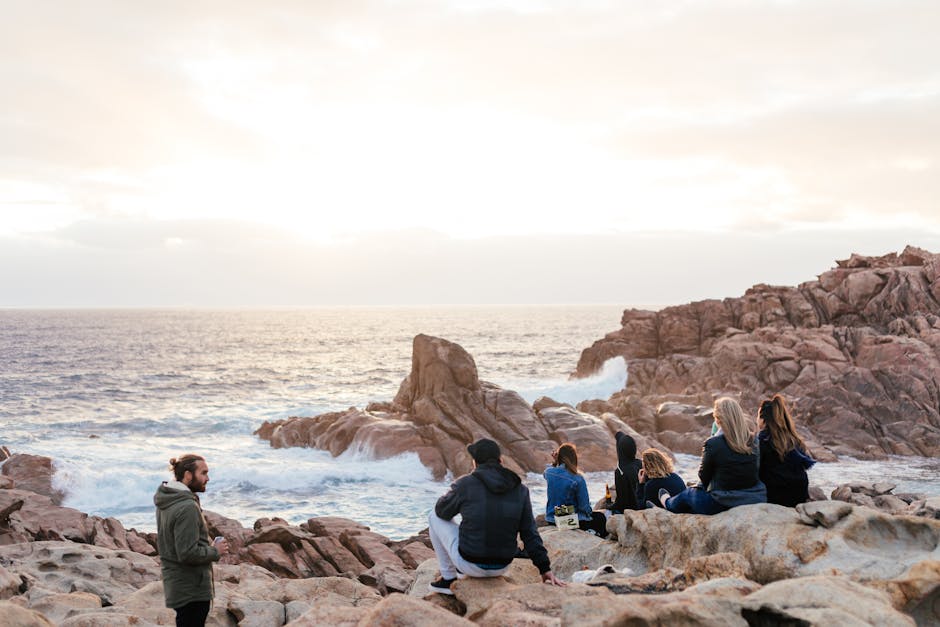 Group enjoying moonlit coastal panorama at Torre Zingari