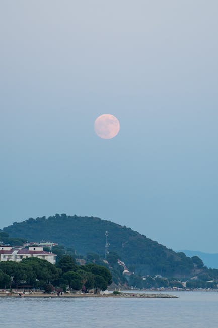 Full moon rising over a Calabrian coastal town and hill