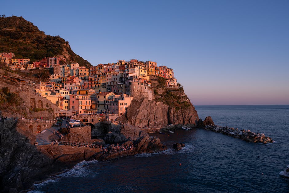 Coastal cliffside village bathed in sunset light, Calabria coastline