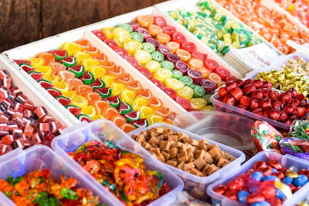 Colorful assorted candies and jellies displayed in market trays in Calabria
