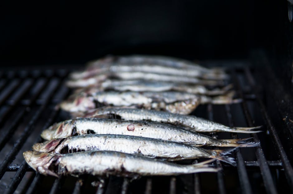 Fresh sardines sizzling on a grill, typical Calabrian seaside cooking