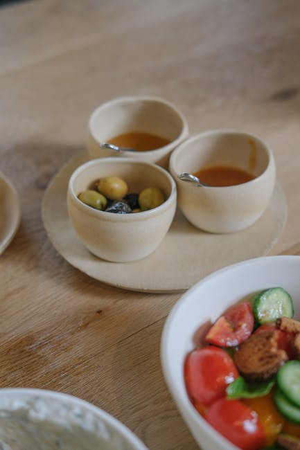 Ceramic bowls of olives and sauces beside fresh salad in Calabria