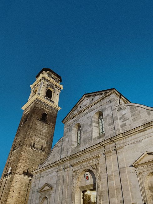 Façade d'église blanche et clocher élevé illuminé dans Trente