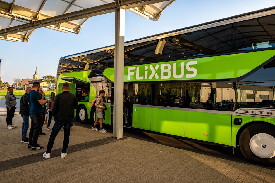 Green FlixBus double-decker boarding passengers at Bari coach stop