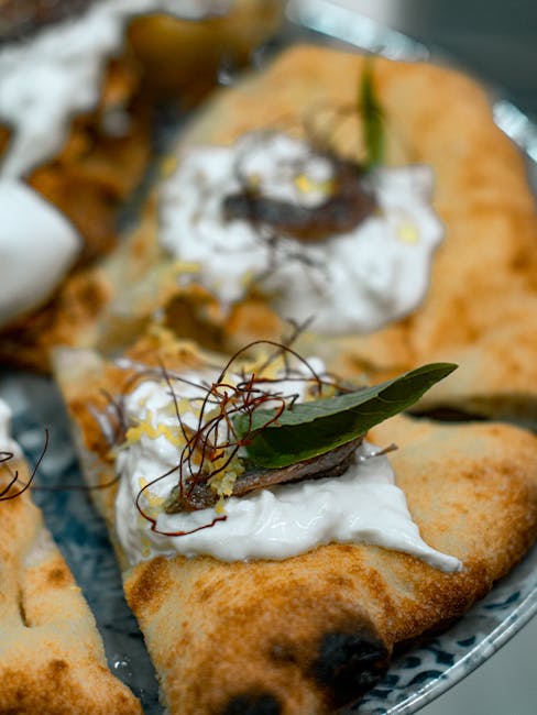 Gourmet focaccia slice topped with creamy burrata, anchovy, and herbs in Bari