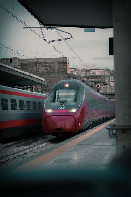 High-speed train pulling into Bari platform under overhead catenary wires
