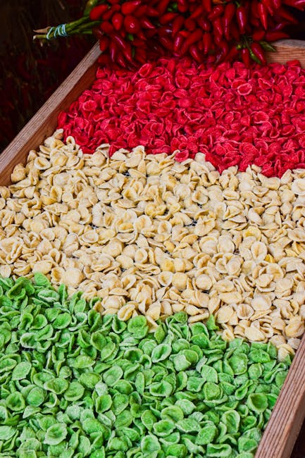 Orecchiette rouges, blanches et vertes alignées sur un étal à Bari