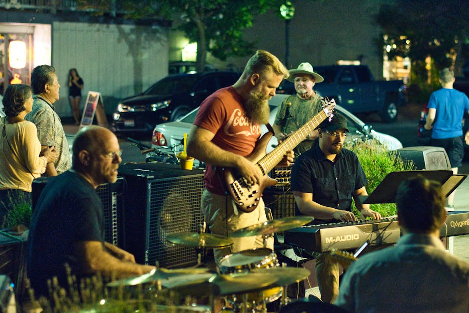 Outdoor jazz band playing instruments for a nighttime Bari crowd.