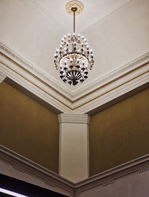 Ornate chandelier suspended from a high decorated ceiling in Bari.