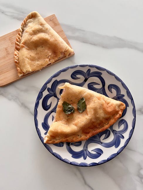 Baked panzerotto on decorative ceramic plate, typical Bari snack presentation