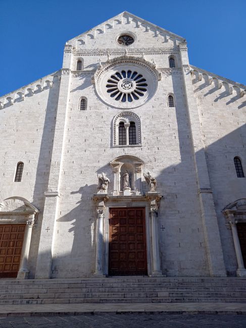 San Nicola Basilica facade in Bari with rose window and wooden doors