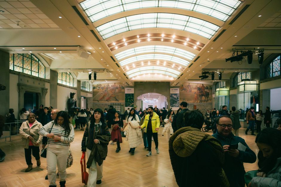 Crowd of visitors walking under arched skylights inside Bari exhibition hall