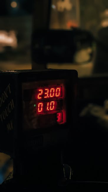 Interior taxi meter glowing 23.00 inside Bari cab at night
