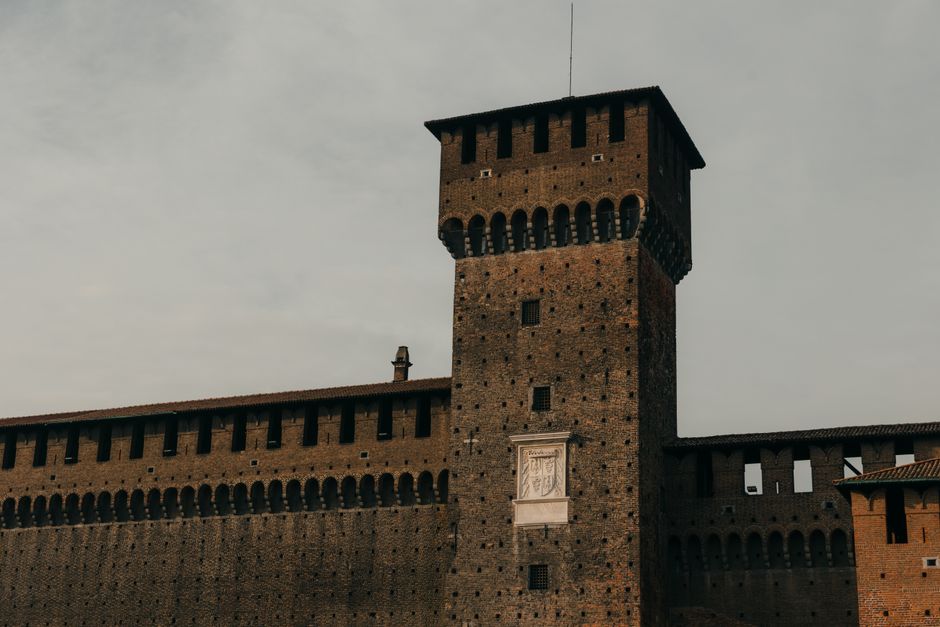 Tall brick tower of Bari's Castello Svevo with crenellated battlements