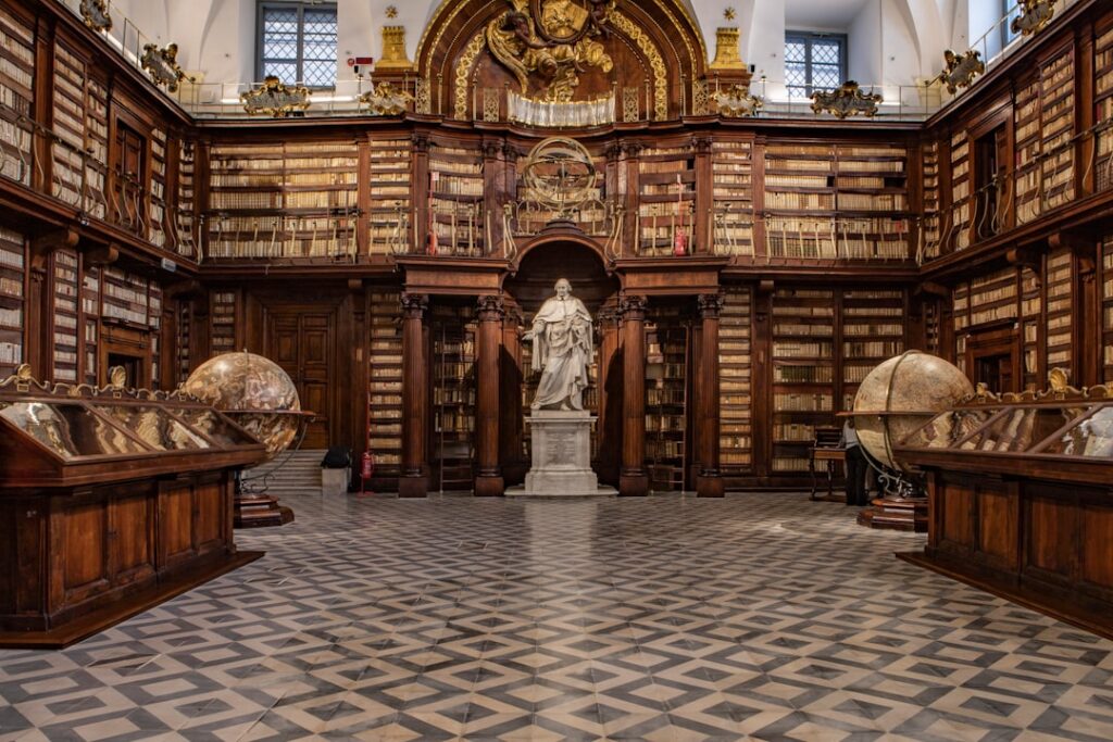 Historic Bari library interior with marble statue, wooden shelves, and globes