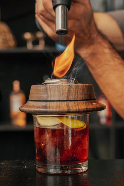 Cocktail flaming under a torch at a Catania rooftop bar