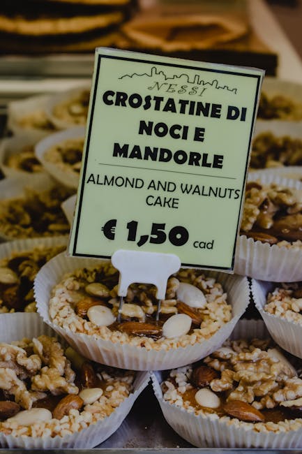 Almond and walnut crostatine with price sign in Catania pastry shop