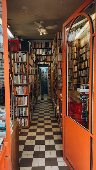 Narrow Catania bookstore aisle with stacked shelves and checkered floor.