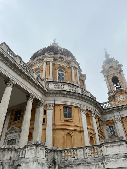 Low-angle view of a yellow domed basilica with columns in Piedmont