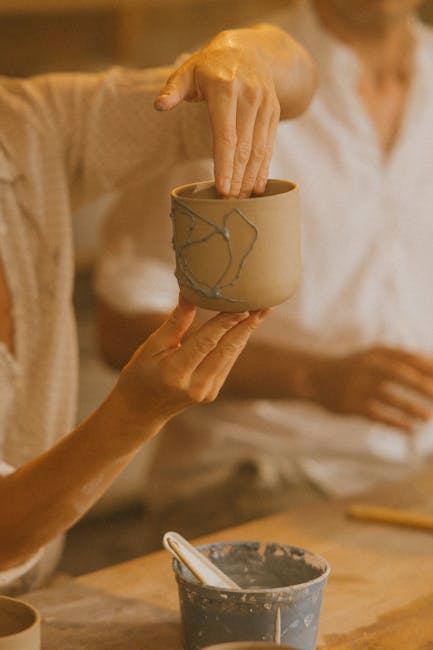Hands presenting handcrafted ceramic cup during a pottery workshop in Piedmont